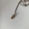 Messing hartjes aan zilveren ketting