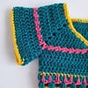 Gehaakt baby vestje | Petrol, roze en geel met roze franjes