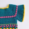 Gehaakt baby vestje | Petrol, roze en geel met roze franjes