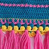 Gehaakt baby vestje | Petrol, roze en geel met roze franjes