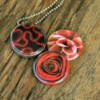 Roestvrij stalen fotomedaillon ketting met drie verschillende verwisselbare voorkanten met close up foto`s in Diep donker rood,zalm en warm rood. Rvs/roesvrij stalen fotomedaillon. Voor het dicht bij je dragen van je favoriete foto.