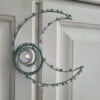 Suncatcher met maan en aquamarijn en delicate levensboom.