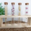 Reageerbuizen met droogbloemen in handgemaakte houder