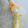 Winnie de Pooh ketting met bijzondere kralen.