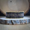 Chic & Sensueel, slangenpatroon armband in zwart en goud