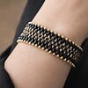 Chic & Sensueel, slangenpatroon armband in zwart en goud