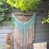 Wandhanger turquoise, beige.