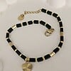 Elegante armband met zwarte Agaat & hartje – RVS 16K verguld