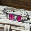 Zilverkleurige armband met roze details