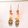 Halloween oorbellen met doodshoofdjes – vrolijke oranje en roze oorhangers