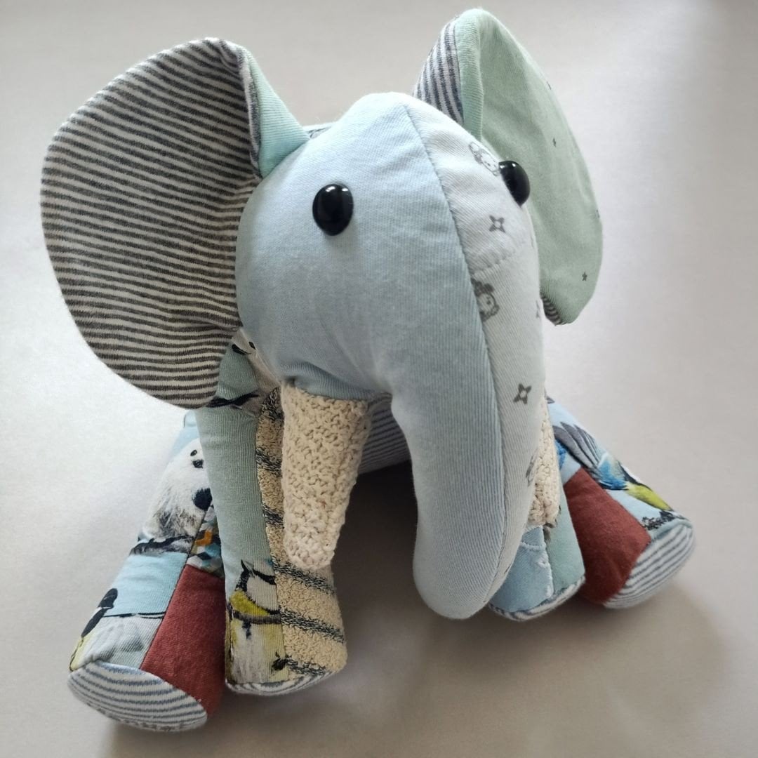 Herinneringsolifant van eerste babykleertjes