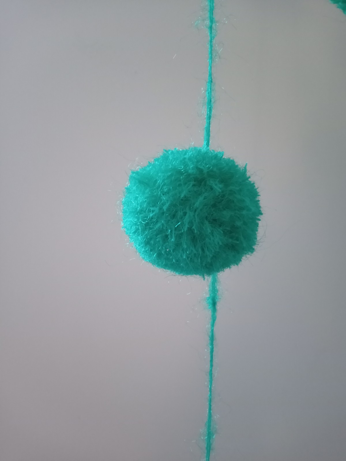 slinger met pomponnetjes, groen