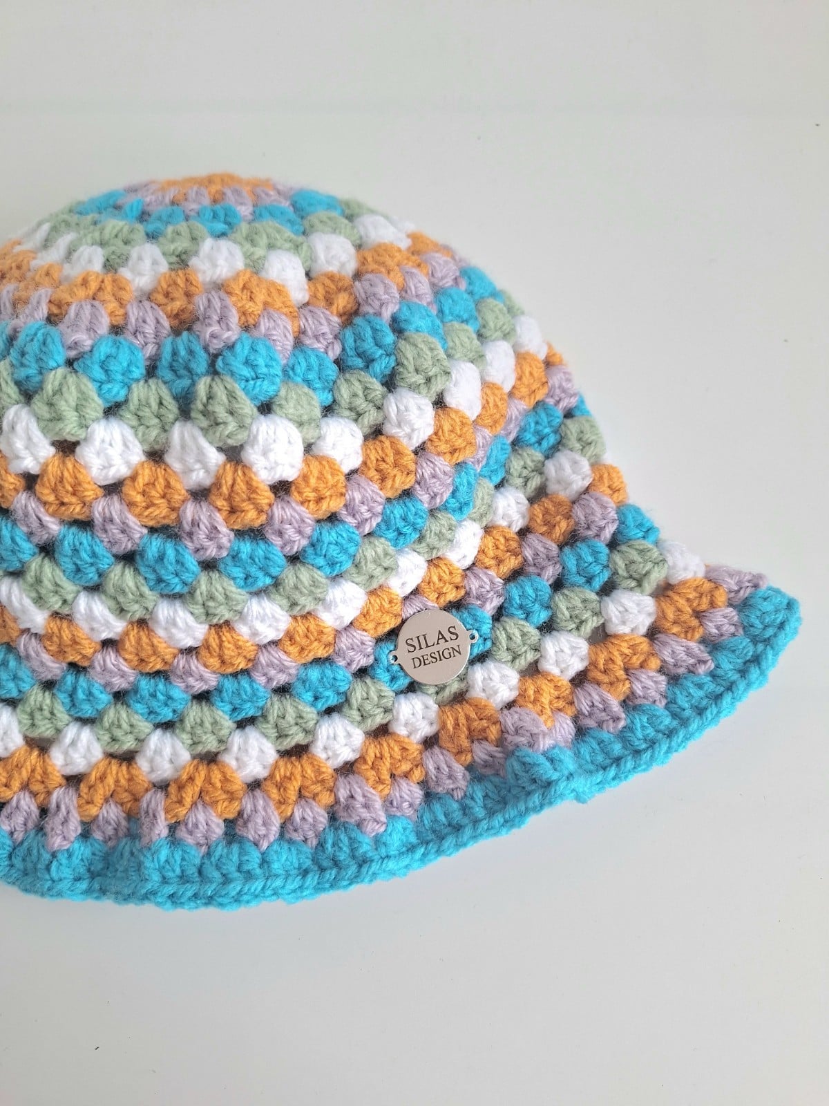 Gehaakte bucket hat | Oranje, lila, turquoise, sagegroen en wit