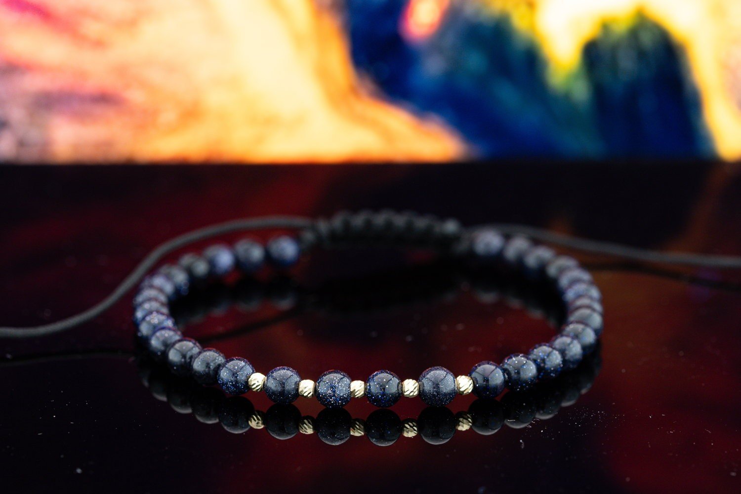 Blauwe goudsteen armband met 14 karaat geelgouden kralen