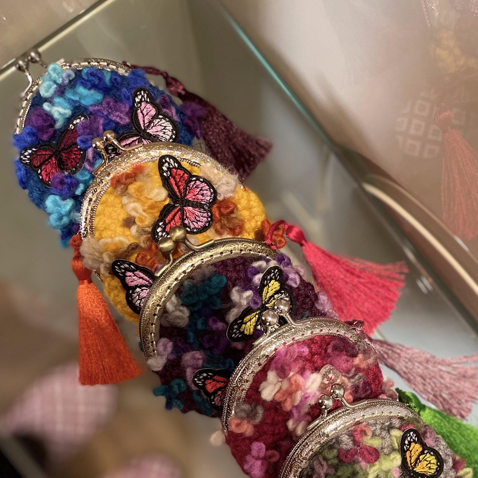 Gehaakte wollen muntjes portemonnee met vlinders erop
