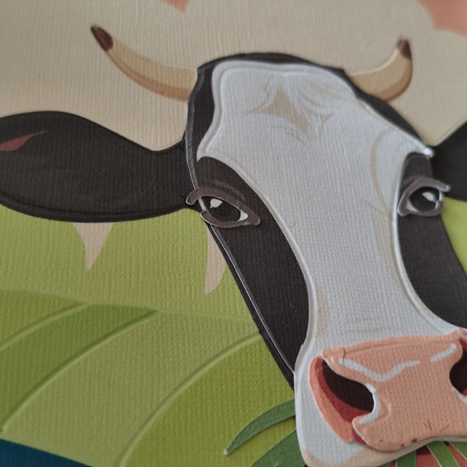 Paper cut-out art – handgemaakte illustraties: Zomerse dorpsidylle met koe in het weiland