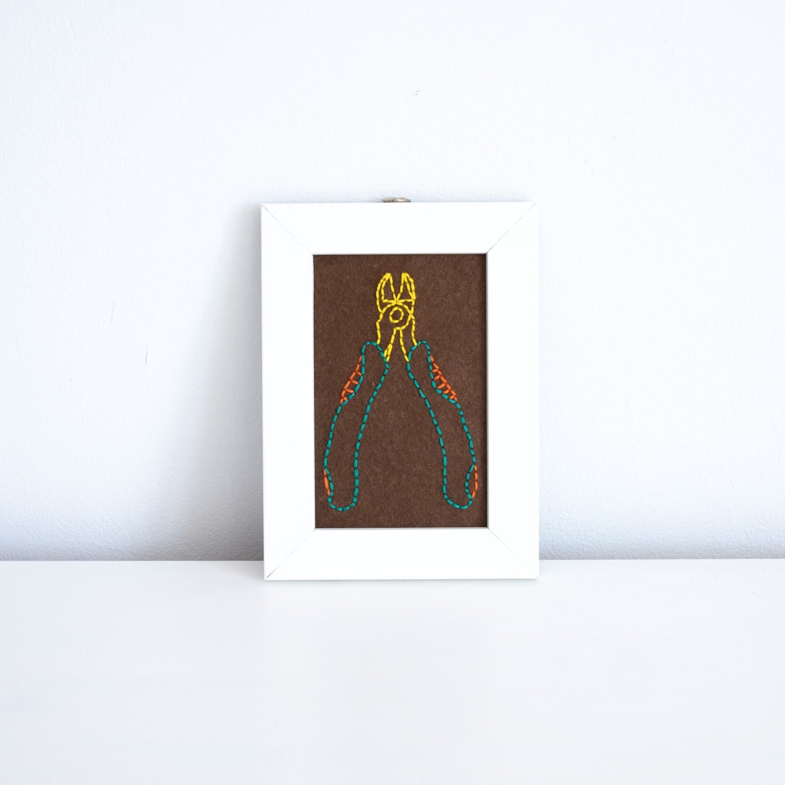 Grappig borduurwerk in hergebruikt frame, tang, gerecyclede lijst, raar borduursel, gek cadeautje, wall art, kniptang, gereedschap