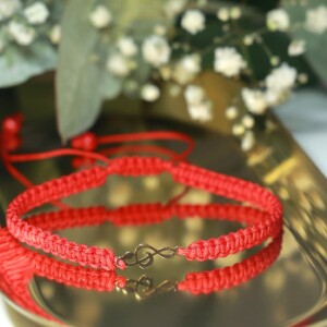 Gevlochten armband met 14 karaat geelgouden muziek G-sleutel