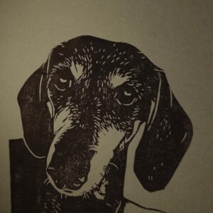 Linoprint ‘Takkie de Teckel’ – gesigneerde A5 hondenkaart in zwart op grijs papier