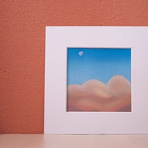 Klein schilderij in de wolken