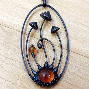 Handgemaakte vliegenzwamketting met rood en oranje glas en zwart gepatineerd koper