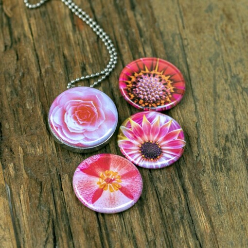 Foto medaillon ketting met 4 verschillende verwisselbare voorkanten met close up foto`s van zacht roze,diep roze en zalm kleurige bloemen, binnen in komt de foto die je graag dicht bij je draagt